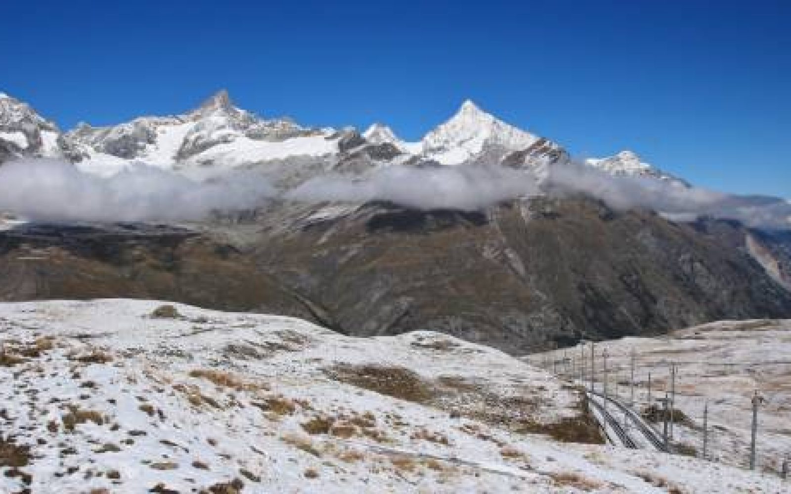 View from Riffelberg, Zermatt. Autumn scene. Wisshorn and other high mountains. Track of the Gornergrat railway.